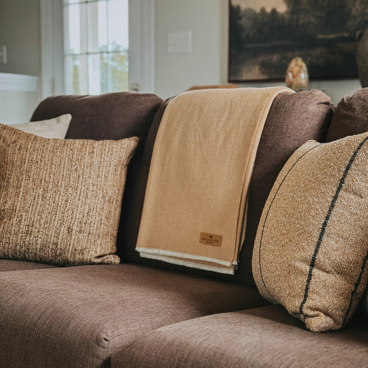 aspen peaks throw in almond on a brown couch