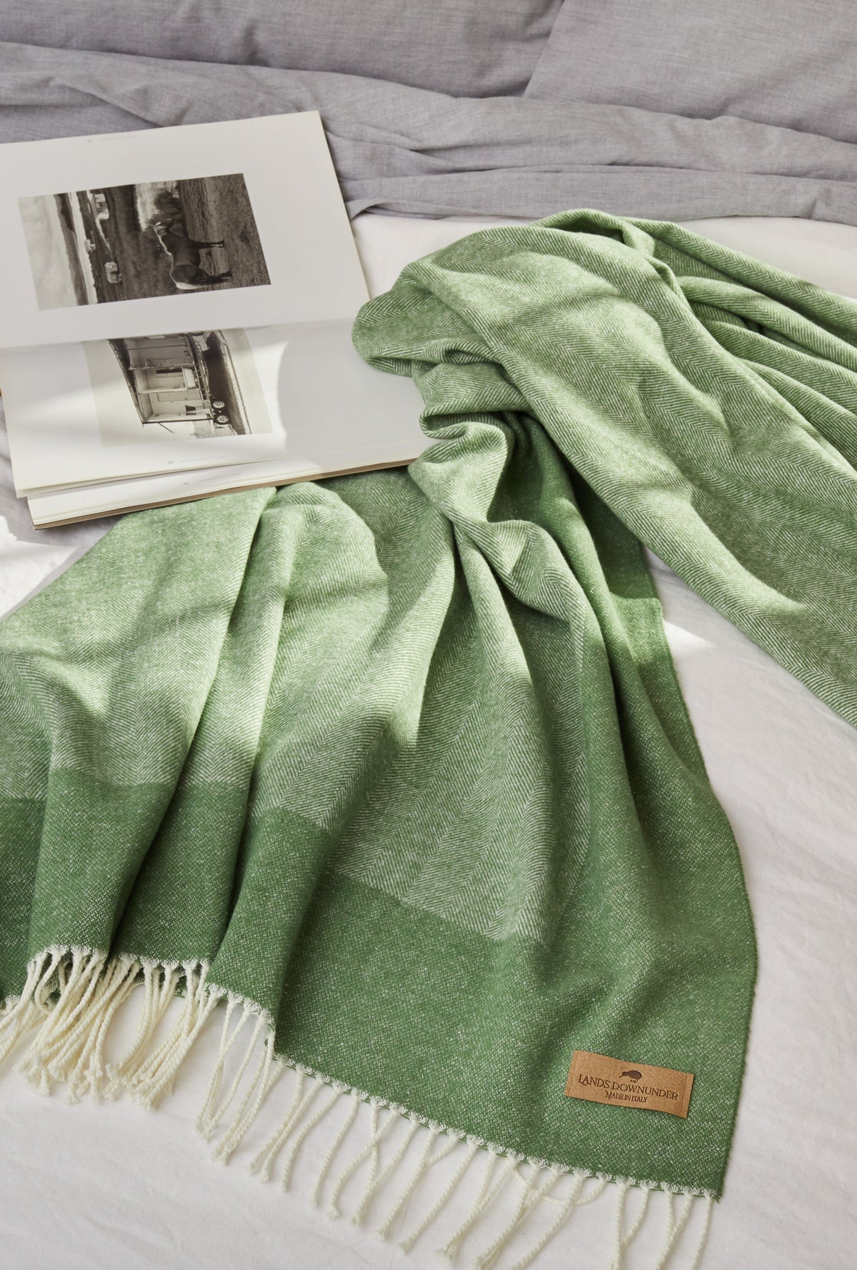olive herringbone throw blanket on bed
