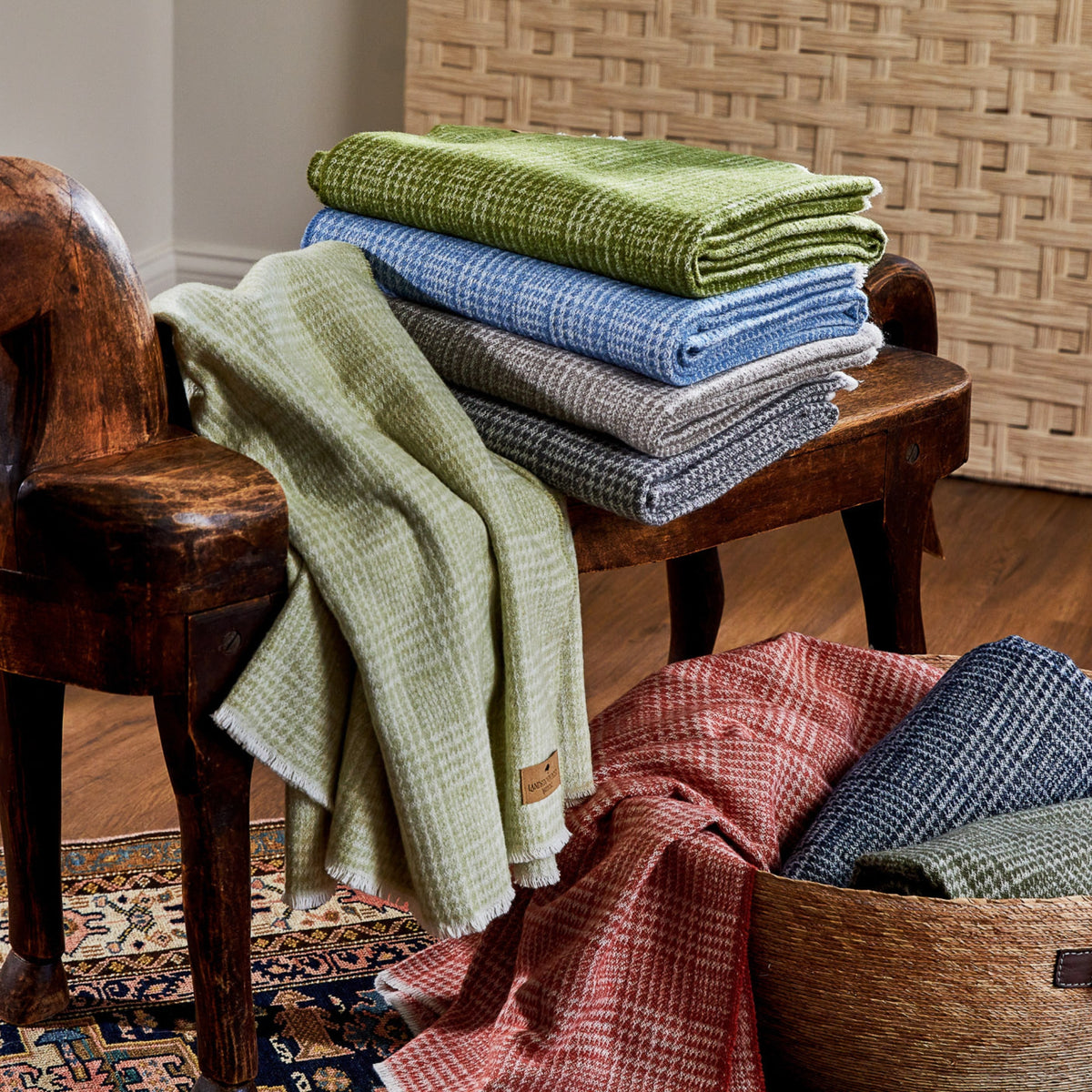 sutton plaid throw blanket collection shot on wooden bench